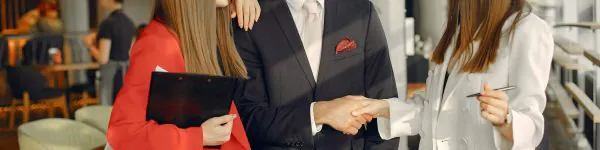 Man and two beautiful women working. People in a cafe. Twins in a elegant suits